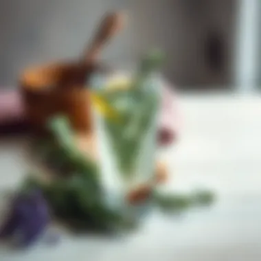 Rosemary-Infused Water A clear glass filled with rosemary-infused water surrounded by herbs