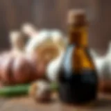A close-up of black garlic oil in a glass bottle with garlic cloves in the background