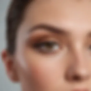 Close-up of a makeup artist applying light brown eyeshadow