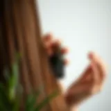 User applying tea tree oil to hair